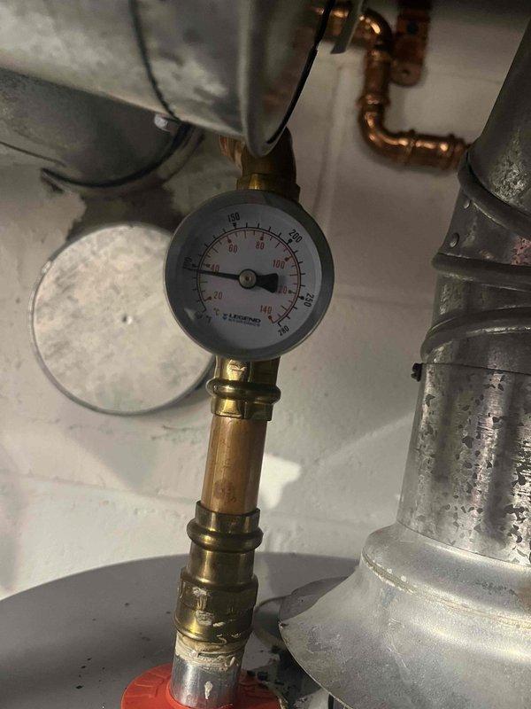 Diagnosed garage heating system failure caused by non-functioning Taco circulation pump. Verified pump was receiving proper power (2.8A) but not circulating water. System pressure reading at 80 PSI confirmed adequate pressure. Replaced defective circulation pump to restore proper water flow and heat to garage zone.