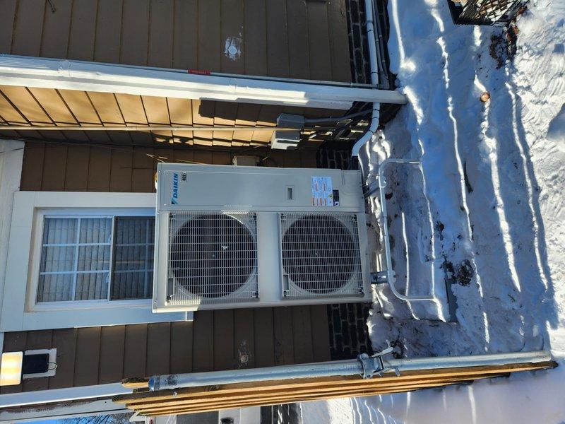 Replaced defective Daikin outdoor condenser unit under warranty. Installed new unit on existing pad and reconnected electrical components and refrigerant lines. System is now operational with proper airflow and electrical connections verified.