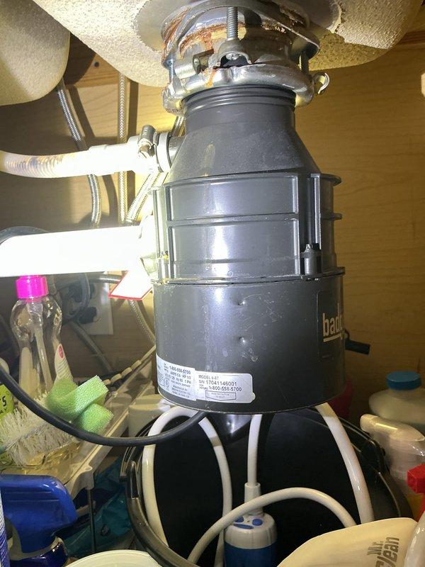 Performed follow-up service on previously sold tankless water heater maintenance. Customer reported water on vent; upon inspection, found no issues with the tankless unit. Examined under-sink plumbing including P-trap assembly and garbage disposal, confirming all components were properly connected with no active leaks or damage.
