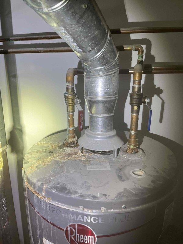 Diagnosed and repaired a leaking 40-gallon Rheem Performance Plus natural gas water heater. Identified corrosion and failed solder joint at the top copper pipe connection, which showed significant oxidation and dripping. Replaced the compromised fitting and resealed the connection to prevent further leakage.