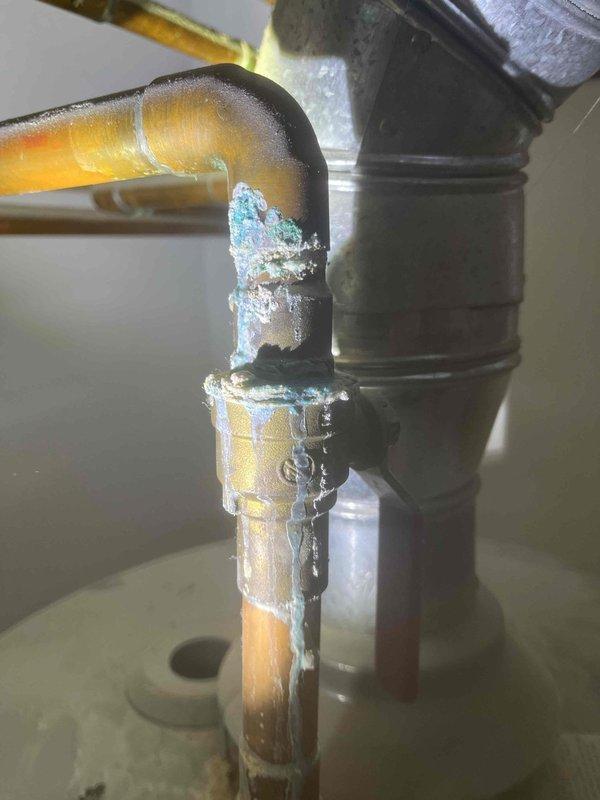 Diagnosed and repaired a leaking 40-gallon Rheem Performance Plus natural gas water heater. Identified corrosion and failed solder joint at the top copper pipe connection, which showed significant oxidation and dripping. Replaced the compromised fitting and resealed the connection to prevent further leakage.