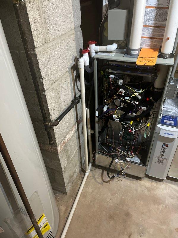 Completed installation of complete HVAC system as part of return service sold by Justindz. Performed pressure testing with CPS V220 digital manometer to verify system integrity. Installed and connected new furnace with proper electrical connections and PVC condensate drainage system in the mechanical room.