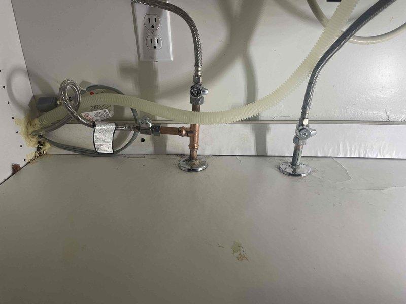 Responded to emergency call from Greg Viviani regarding active water leak under sink where a nozzle had blown out. Inspected the sink plumbing system and discovered a failed connection at the P-trap assembly. Replaced the damaged section and verified proper drainage function with no leaks after repair.