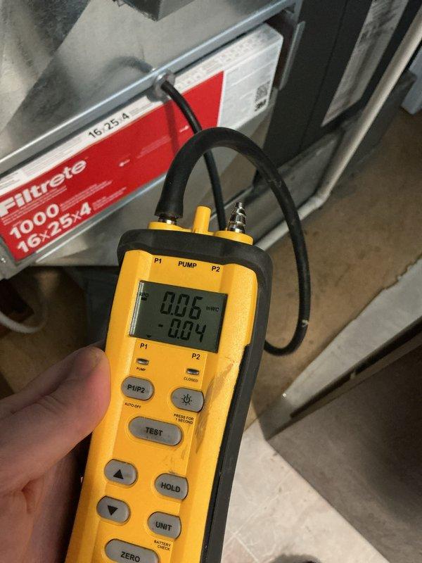 Responded to customer complaint of heat pump showing warning light with 12 flashes and condenser short cycling. Diagnostic testing revealed low voltage (23.96V) and high amperage (19.54A) at the Trane unit. Performed static pressure measurements (0.06/-0.04) and verified proper air filtration system. Reset system and confirmed proper operation with normalized electrical values and elimination of warning codes.