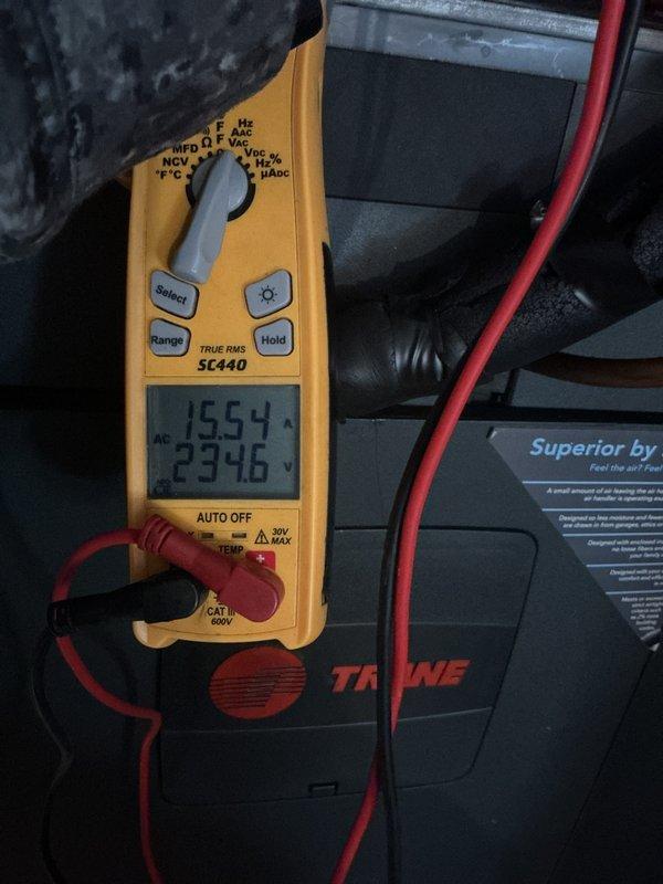Responded to customer complaint of heat pump showing warning light with 12 flashes and condenser short cycling. Diagnostic testing revealed low voltage (23.96V) and high amperage (19.54A) at the Trane unit. Performed static pressure measurements (0.06/-0.04) and verified proper air filtration system. Reset system and confirmed proper operation with normalized electrical values and elimination of warning codes.