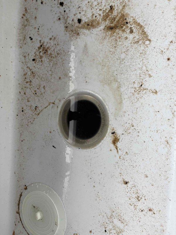 Responded to service call for clogged garbage disposal (PRO 77 Quiet System model). Inspection revealed significant debris buildup and brownish staining inside the disposal drain. Successfully cleared the clog and restored proper drainage functionality.
