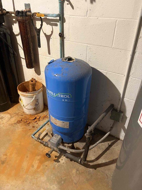 Responded to service call for complete loss of water pressure (0 PSI on gauge). Inspected Well-X-Trol pressure tank and associated plumbing components. Performed electrical testing using CEN-TECH clamp meter to verify proper pump operation. Diagnosed and resolved pressure issue, restoring system functionality.