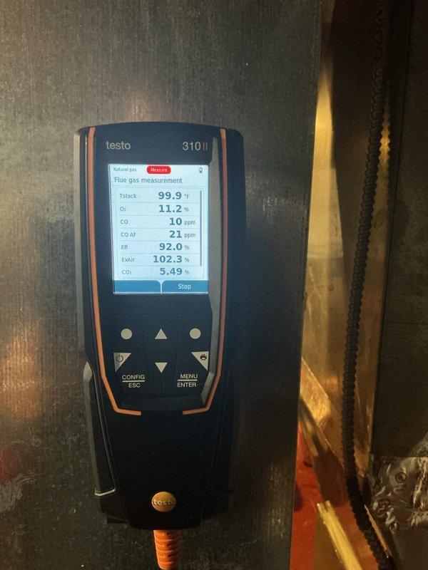 Performed combustion analysis on heating system using Testo 310 II gas analyzer. Readings showed 92.0% efficiency with 10ppm CO and 102.3% excess air. Inspected heat exchanger fins and found them intact with no visible cracks or deterioration.