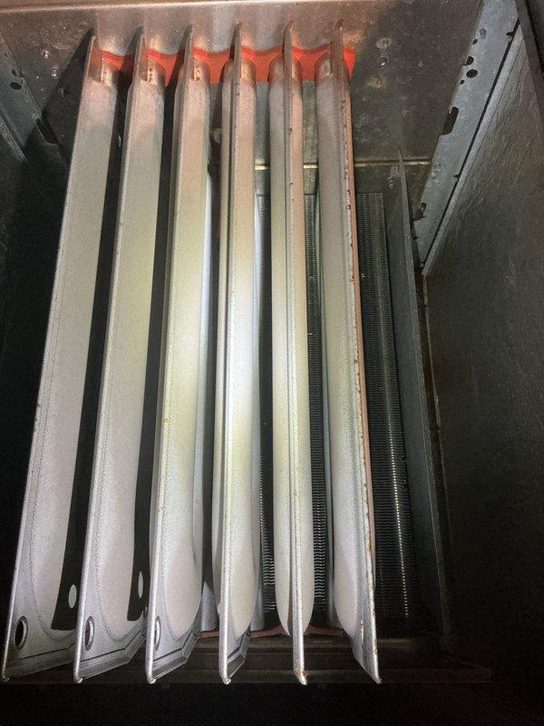 Performed combustion analysis on heating system using Testo 310 II gas analyzer. Readings showed 92.0% efficiency with 10ppm CO and 102.3% excess air. Inspected heat exchanger fins and found them intact with no visible cracks or deterioration.