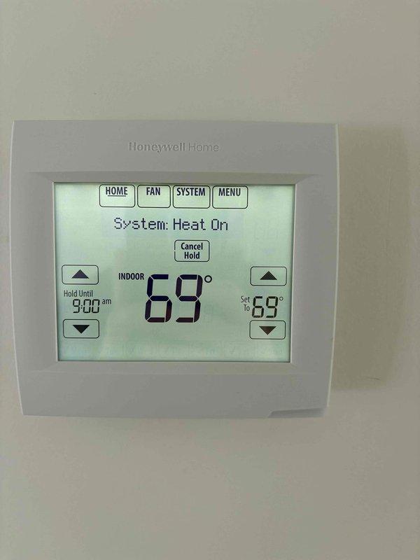 Conducted an estimate for replacement of existing furnace. Assessed current HVAC system installation in utility area, noting condition of existing unit, ductwork, and PVC ventilation configuration. Verified compatibility with current Honeywell digital thermostat system which is functioning properly with heat mode operational.