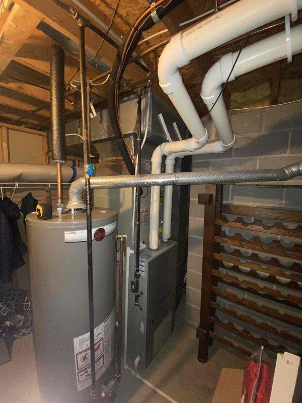 Conducted assessment for whole home humidifier installation in client's basement utility area. Measured existing HVAC equipment and evaluated available installation space adjacent to the furnace unit. Inspected current plumbing configuration and PVC pipe network to determine optimal connection points for the proposed humidification system.