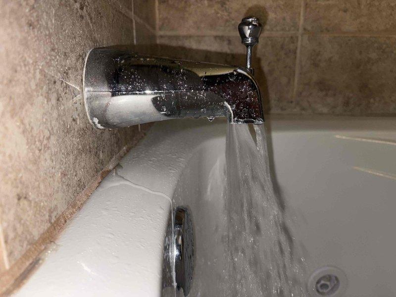 Diagnosed low water pressure issue in master shower. Pressure gauge testing revealed system operating at approximately 90 PSI, which is within acceptable range. Performed thorough inspection of shower head and faucet assembly, cleaned mineral deposits from diverter mechanism and shower head to restore proper water flow. Confirmed normal operation after service with consistent pressure throughout all fixtures.