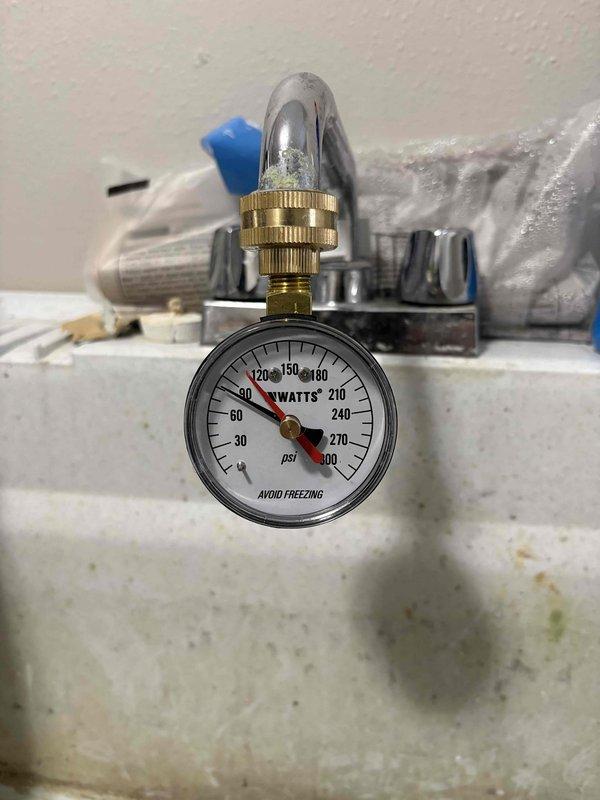 Diagnosed low water pressure issue in master shower. Pressure gauge testing revealed system operating at approximately 90 PSI, which is within acceptable range. Performed thorough inspection of shower head and faucet assembly, cleaned mineral deposits from diverter mechanism and shower head to restore proper water flow. Confirmed normal operation after service with consistent pressure throughout all fixtures.