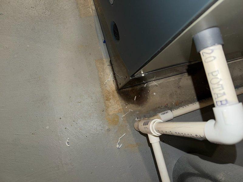 Completed service call to address improperly installed furnace panel. Retrieved drain kit from office and properly secured the access panel. Inspected system internals including electrical connections, circuit board, and drainage components. Noted water staining on adjacent wall indicating possible previous moisture issues.