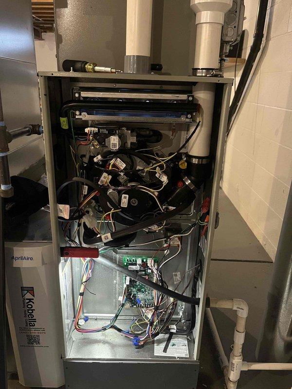 Completed service call to address improperly installed furnace panel. Retrieved drain kit from office and properly secured the access panel. Inspected system internals including electrical connections, circuit board, and drainage components. Noted water staining on adjacent wall indicating possible previous moisture issues.