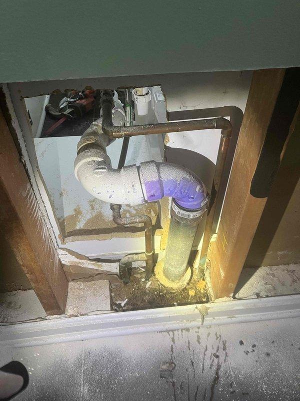 Returned to complete jackhammer work on concrete slab as previously sold by Chris. Exposed plumbing infrastructure beneath sink fixture to address water damage evident on concrete floor. Removed damaged materials and accessed wall cavity to evaluate plumbing connections and drainage system where moisture intrusion had occurred.