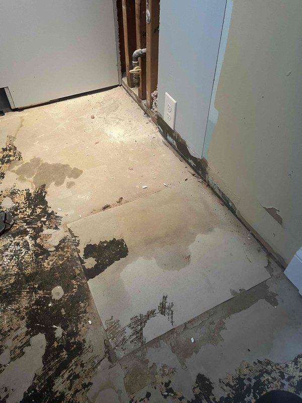 Returned to complete jackhammer work on concrete slab as previously sold by Chris. Exposed plumbing infrastructure beneath sink fixture to address water damage evident on concrete floor. Removed damaged materials and accessed wall cavity to evaluate plumbing connections and drainage system where moisture intrusion had occurred.
