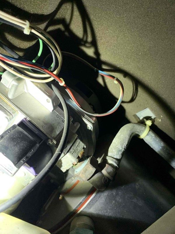 Responded to service call for non-functioning boiler with reported blower assembly error code. Performed electrical diagnostics with Fieldpiece SC480 multimeter, measuring 386.4V at input terminals. Inspected internal components and identified corrosion at pipe joint connections within the mechanical assembly. Cleaned corroded connections and restored proper operation of the heating system.