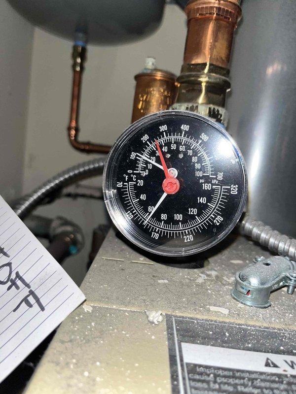 Responded to no-heat call for 5-6 year old gas boiler. Inspected system and found low pressure reading on boiler gauge. Serviced manifold system, purged air from distribution lines, and restored proper system pressure. Unit now operating normally with consistent heat output.