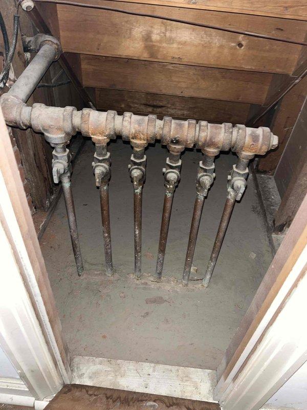 Responded to no-heat call for 5-6 year old gas boiler. Inspected system and found low pressure reading on boiler gauge. Serviced manifold system, purged air from distribution lines, and restored proper system pressure. Unit now operating normally with consistent heat output.