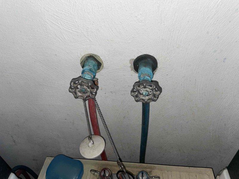 Diagnosed and repaired bladder tank that was cycling on and off every minute or two causing water supply issues. Inspected existing bathroom fixtures and determined multiple outdated toilets and faucets require replacement, which was documented with photos of the current plumbing valves and shower installation.