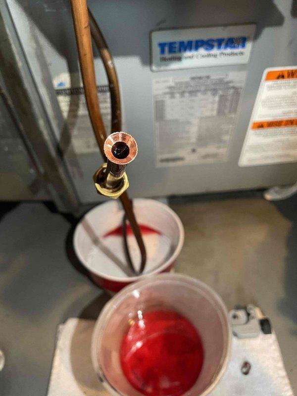 Inspected oil furnace reporting black soot issues. Identified pump seal failure as the source of the problem, evidenced by deteriorated seals that were removed and documented. Performed system flush with cleaning solution to remove contaminants before installing replacement seals.