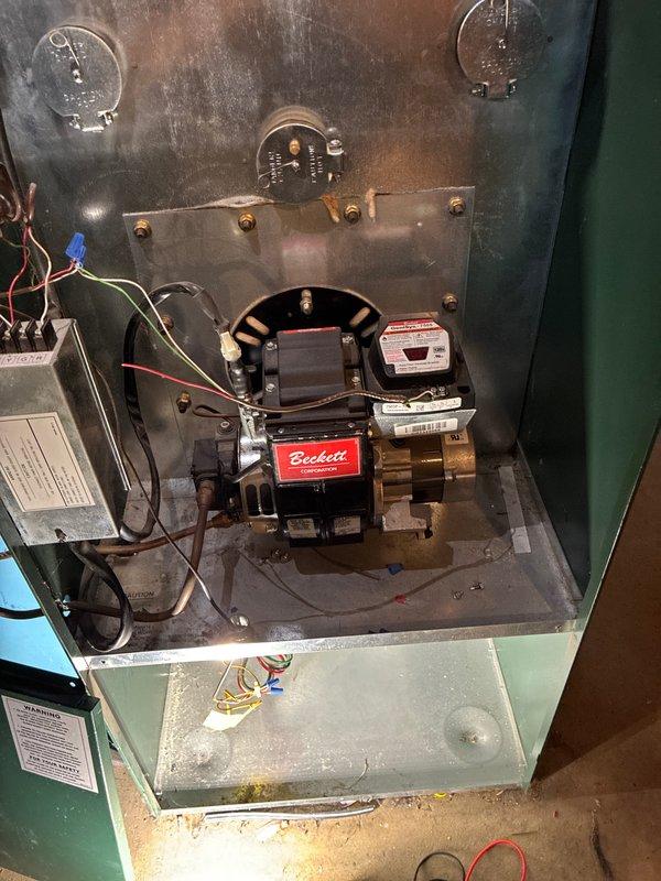 Diagnosed and serviced oil furnace that was not producing heat. Inspection revealed electrical issues within the Beckett oil burner assembly requiring wire reconnection and component testing. System was successfully restored to proper operation with heat output confirmed.