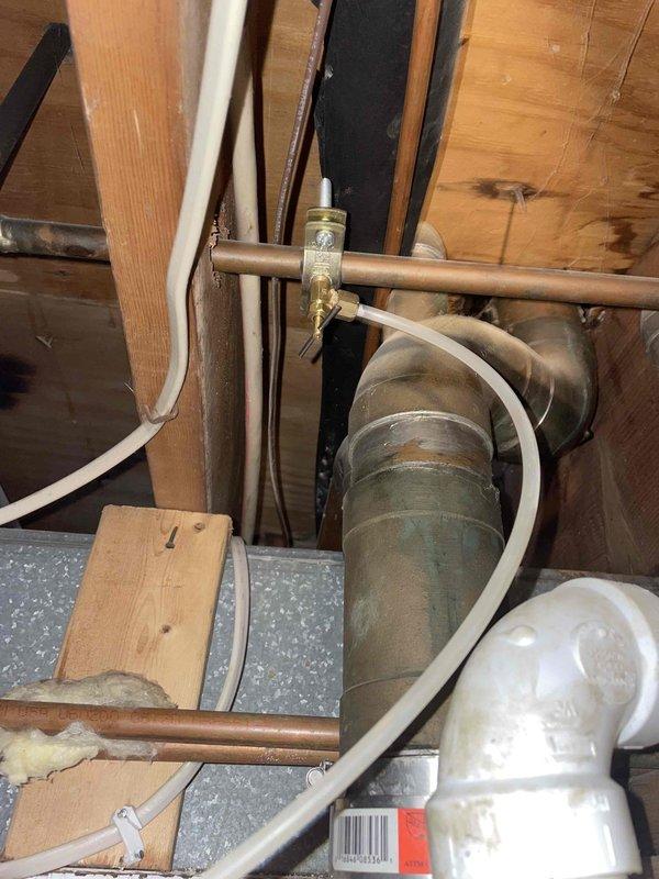 Responded to a water leak call involving the refrigerator water line. Inspected the plumbing infrastructure in the utility area, identifying a leak at the connection point between copper and PVC piping. Repaired the issue by replacing the metal coupling and securing with new clamps, then tested the water line to ensure proper function and no further leakage.