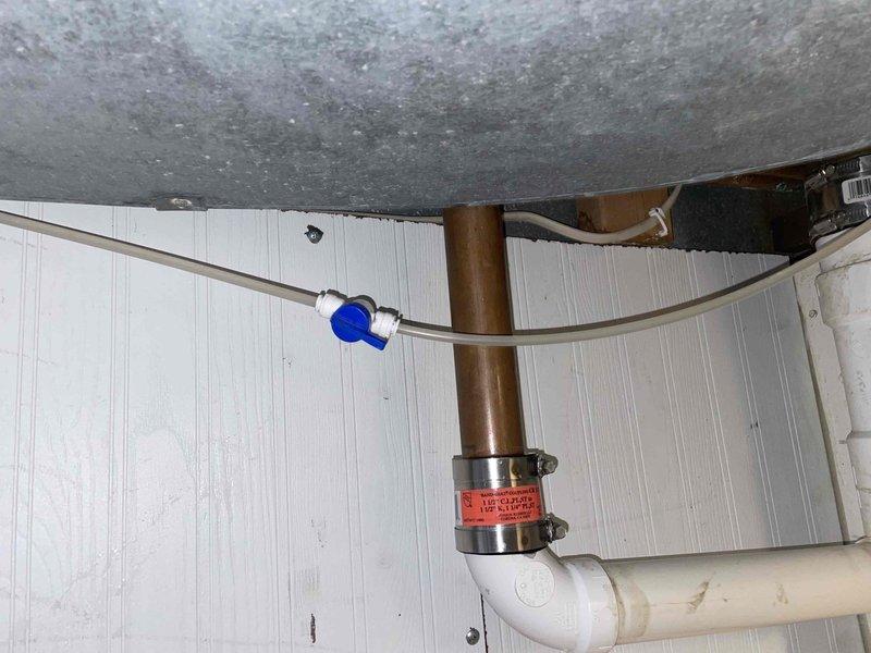 Responded to a water leak call involving the refrigerator water line. Inspected the plumbing infrastructure in the utility area, identifying a leak at the connection point between copper and PVC piping. Repaired the issue by replacing the metal coupling and securing with new clamps, then tested the water line to ensure proper function and no further leakage.
