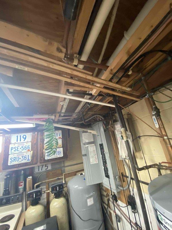 Responded to a lead from Sam K regarding no heat issue. Inspected furnace in unfinished basement with exposed joists and plumbing infrastructure. Diagnostic review indicated unit requires replacement; photos documented current installation conditions including nearby electrical panel and water treatment equipment.