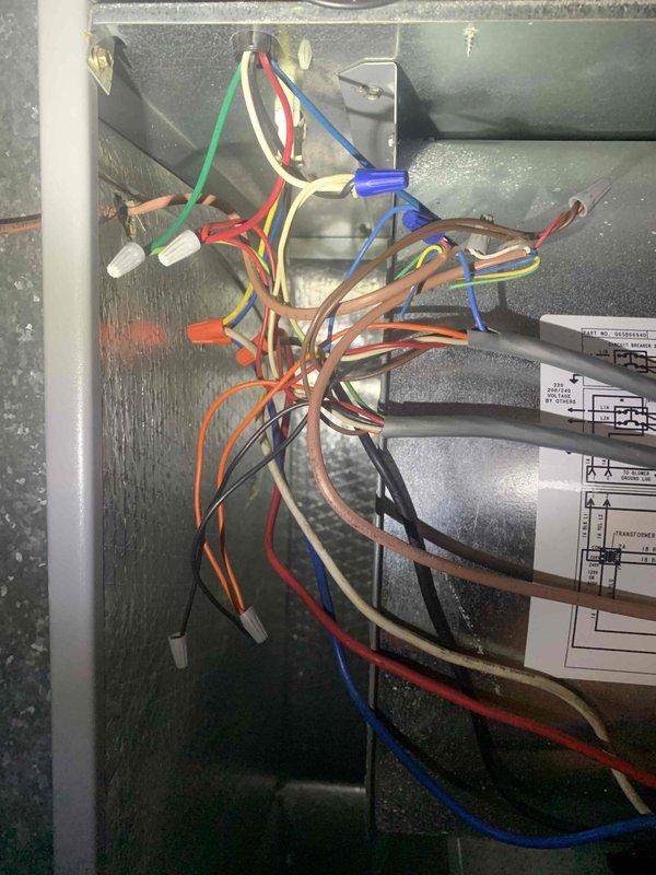 Diagnosed 10-year-old heat pump system with non-functioning cooling/heating operation while auxiliary heat remained operational. Inspection revealed faulty wiring connections at both the thermostat control panel and indoor air handler, specifically with the R, C, and OB terminals. Repaired loose and improperly terminated connections, restoring proper communication between thermostat and heat pump system.