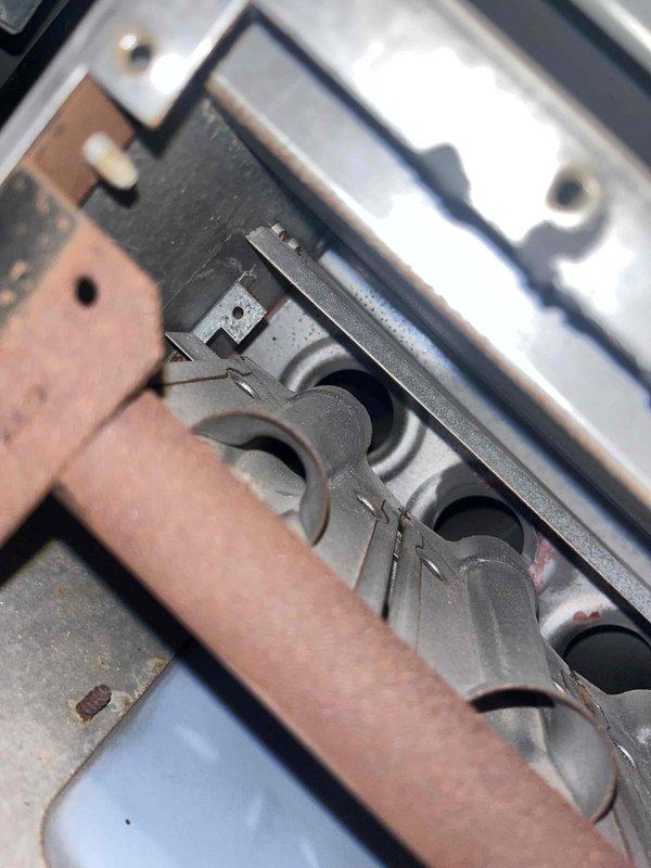 Diagnosed 25-year-old furnace with ignition sequence issue where flame ignites but blower motor fails to activate. Inspection of control board revealed corrosion damage on lower components and deteriorating heat exchanger tubes, indicating end-of-life system failure. Recommended replacement due to age and condition of critical components.