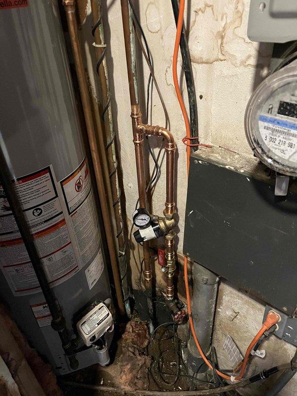 Responded to service call for faucet repair. Located and replaced cartridge as per customer's prior arrangement. Inspected surrounding plumbing system including copper piping, pressure gauge, and water heater connections to ensure proper functionality after cartridge replacement.