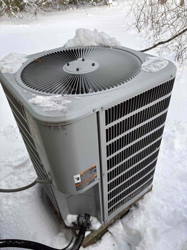 Responded to service call for non-functioning cold climate heat pump. Inspection revealed unit was completely covered in snow, restricting proper airflow. Electrical system inspection showed reversed lead connections at air handler. Corrected wiring issue and cleared snow accumulation from outdoor unit to restore normal operation. Customer advised on proper winter maintenance to prevent future issues.