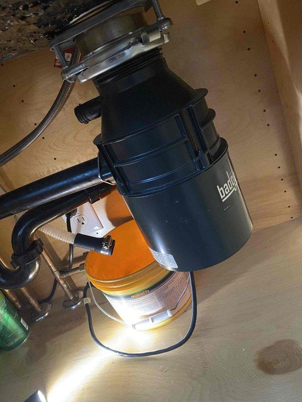 Replaced two leaking bathroom faucets and installed new garbage disposal unit in kitchen sink. Completed full plumbing connections including P-trap configuration and supply lines with proper hot/cold water connections.