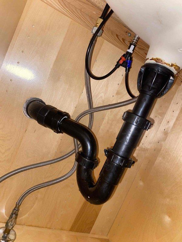 Replaced two leaking bathroom faucets and installed new garbage disposal unit in kitchen sink. Completed full plumbing connections including P-trap configuration and supply lines with proper hot/cold water connections.