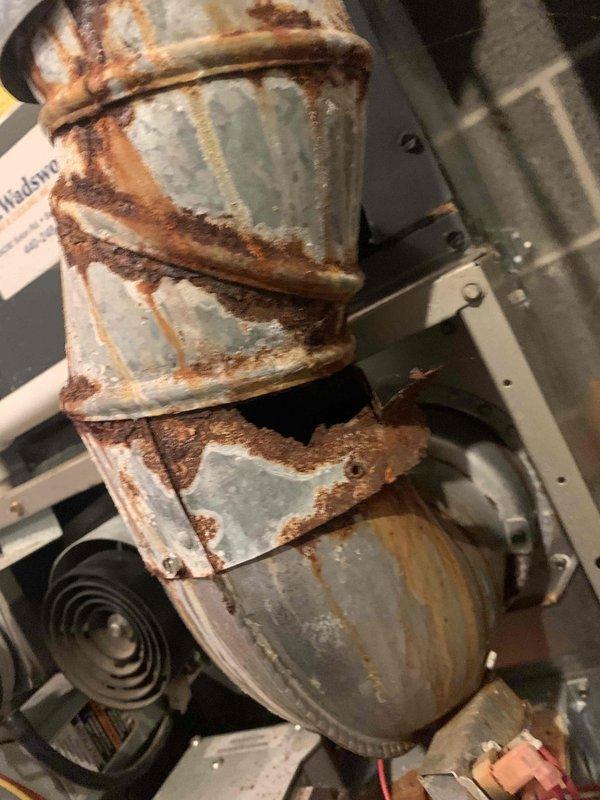 Responded to service call for two non-igniting furnaces. Inspection of Carrier model 58DLA110---12116 (manufactured July 2020) revealed severe corrosion and structural damage to the exhaust flue pipe. Replaced damaged flue components to restore proper venting and ensure safe operation of both units.
