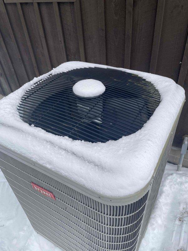 Responded to no heat complaint at residence. Found system unable to maintain temperature with thermostat reading 46°F despite 68°F heat setting. Outdoor unit was covered in snow, restricting proper airflow and operation. Cleared snow accumulation from unit, verified proper system operation, and confirmed heat restoration to home.