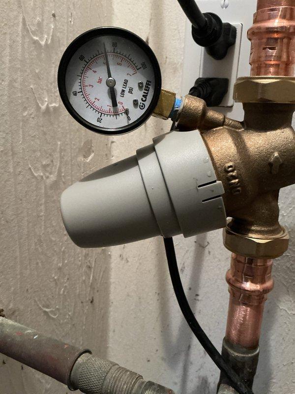 Responded to service call for water hammer issues following recent PRV installation. Diagnostic inspection revealed pressure fluctuations between 70-90 PSI causing pipe knocking. Adjusted pressure regulator valve to stabilize system pressure within normal operating range, eliminating water hammer effect. Verified proper operation of recently installed pressure release valve.