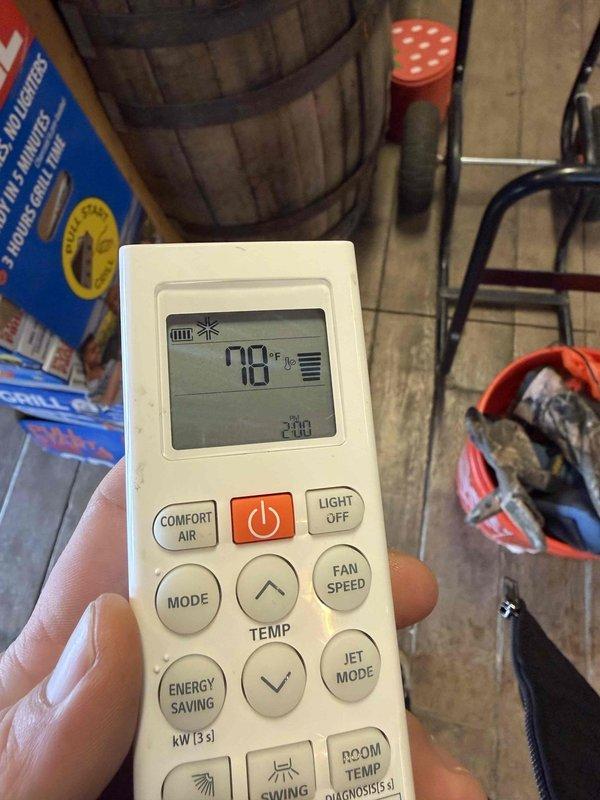 Responded to service call for commercial mini split system with no heat output. Discovered units heavily iced over due to extreme snow accumulation around outdoor condenser unit. Cleared snow/ice buildup from outdoor unit, restored proper airflow, and verified system operation with remote control set to 78°F heating mode.