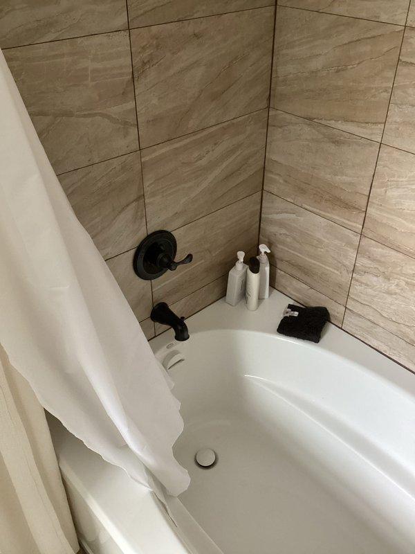 Responded to service call for bathroom faucet leak and potential kitchen sink leak. Inspected black bathroom fixtures showing signs of water damage. Identified poor water heater ventilation causing plastic components to melt; recommended relocating heater closer to b-vent or installing a power vent/tankless system to resolve ventilation issues.