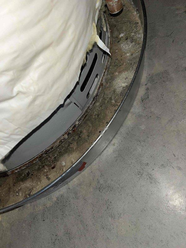 Responded to service call for shower drain backup occurring when toilet was flushed, indicating cross-connection issue in the waste line. Inspection revealed significant corrosion at water heater base requiring documentation. Cleared clogged drain line using auger, restoring proper drainage and eliminating shower bubbling.