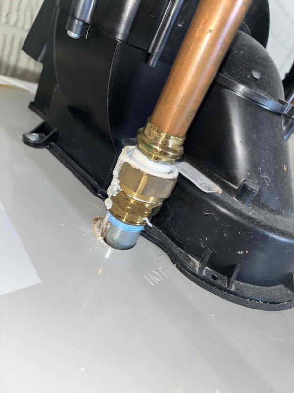 Responded to service call for shower drain backup occurring when toilet was flushed, indicating cross-connection issue in the waste line. Inspection revealed significant corrosion at water heater base requiring documentation. Cleared clogged drain line using auger, restoring proper drainage and eliminating shower bubbling.