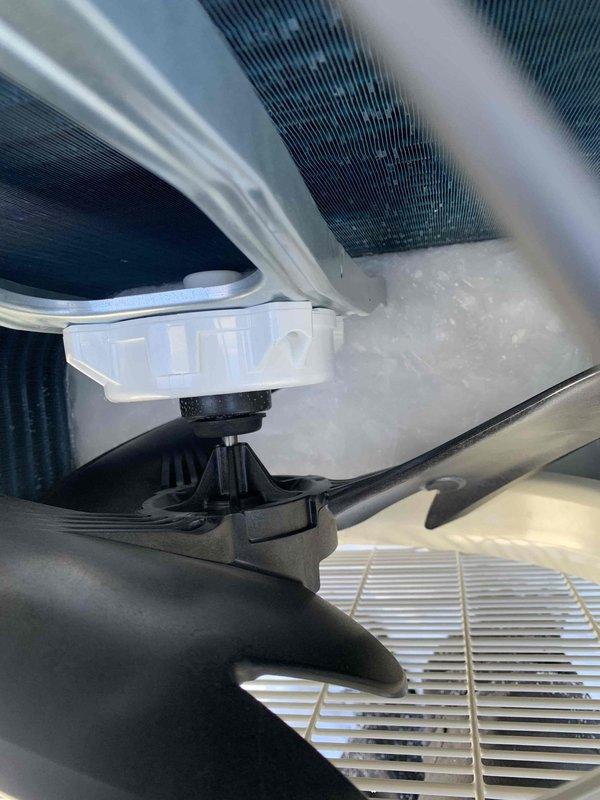 Responded to service call for mini split heat fan malfunction. Discovered outdoor unit heavily encased in snow and ice buildup, significantly obstructing ventilation grills and restricting proper airflow. Cleared accumulated snow/ice from unit, inspected internal components including sensors and heat exchanger coils, and restored system to normal operation.