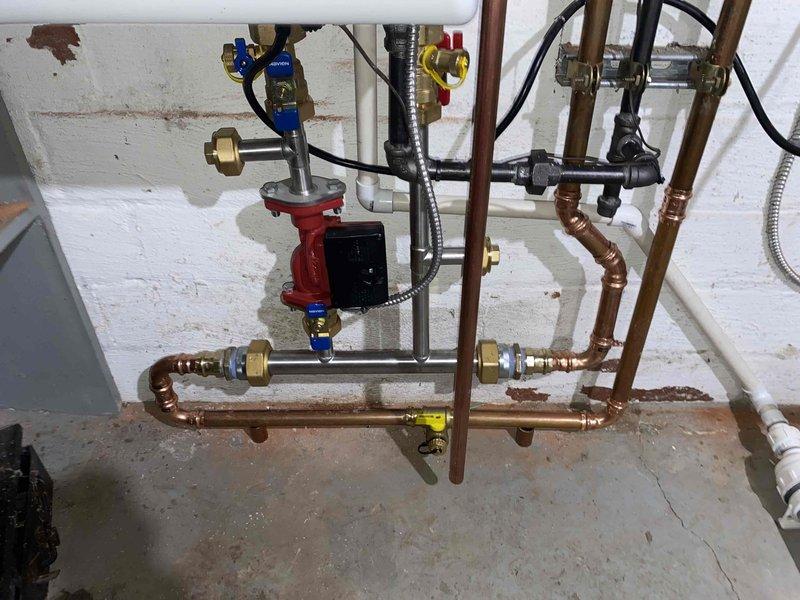 Completed follow-up installation of a Navien boiler system previously sold by Greg and flipped by Sam with KGS approval. Installed copper supply/return lines with proper valves and circulation pump, and connected venting using PVC exhaust pipes. All connections were tested and system was commissioned to manufacturer specifications.