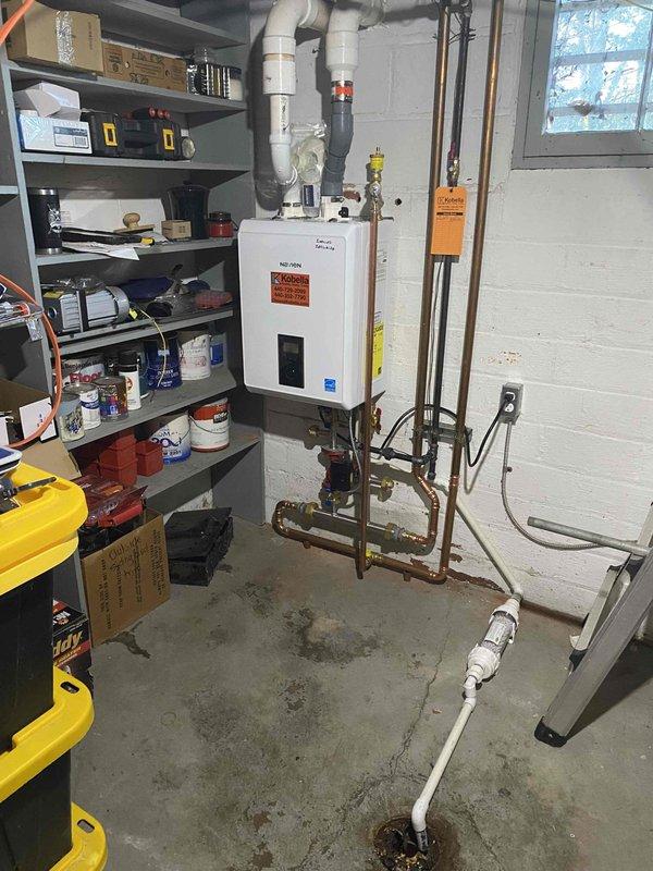 Completed follow-up installation of a Navien boiler system previously sold by Greg and flipped by Sam with KGS approval. Installed copper supply/return lines with proper valves and circulation pump, and connected venting using PVC exhaust pipes. All connections were tested and system was commissioned to manufacturer specifications.