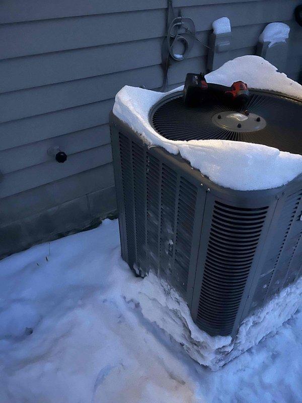 Responded to no heat complaint for Lennox heat pump system. Upon arrival, found outdoor unit covered in significant snow accumulation which was restricting proper airflow and operation. Cleared snow from unit and surrounding area, ensuring proper ventilation for the condenser. System returned to normal operation after snow removal.