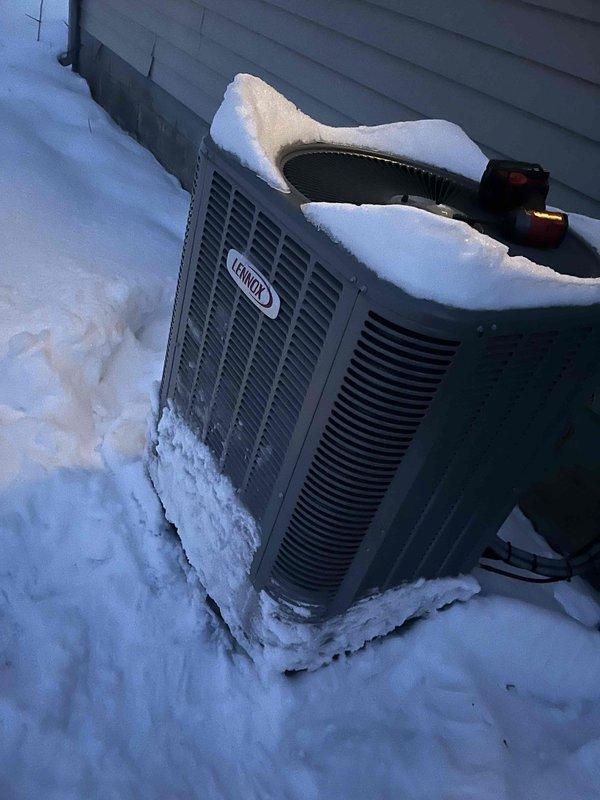 Responded to no heat complaint for Lennox heat pump system. Upon arrival, found outdoor unit covered in significant snow accumulation which was restricting proper airflow and operation. Cleared snow from unit and surrounding area, ensuring proper ventilation for the condenser. System returned to normal operation after snow removal.