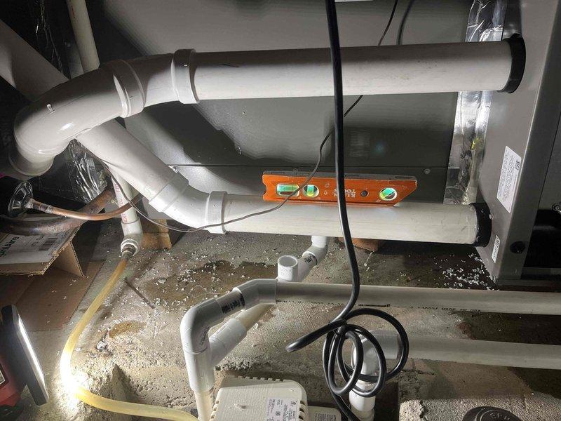 Responded to emergency service call for non-functional furnace in recently installed HVAC system. Inspected condensate drain line system and verified proper installation with spirit level to ensure adequate drainage slope. All connections were secure with no visible leaks detected.