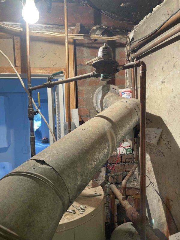 Responded to customer complaint regarding uneven heating where oil boiler was only heating one side of the house. Diagnosed issue with zone valve connection, which was preventing proper distribution of heated water throughout the system. Observed significant corrosion on valve assembly at expansion tank and deteriorating pipe insulation. Reconnected and tested zone valves to restore balanced heating to all areas of the home.